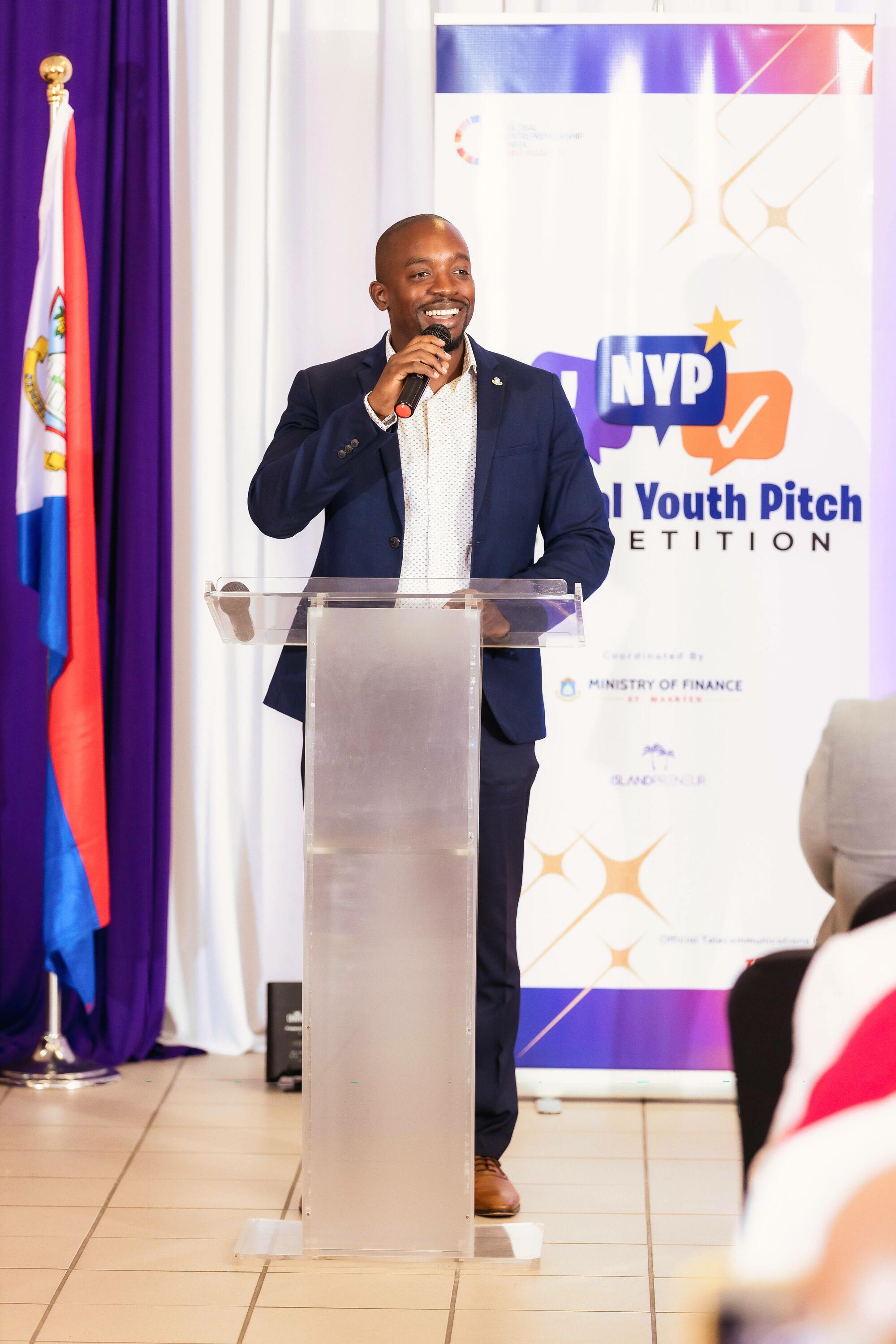 Minister of Finance, Hon. Ardwell Irion speaking with school representatives about National Youth Pitch Competition 