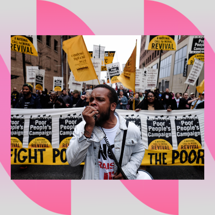  [Image Description: Members of the Poor People’s Campaign: A National Call for Moral Revival marching at a rally in North Carolina. Marchers are holding black and yellow Poor People’s Campaign banners and flags that say Fight Poverty Not the Poor and Everybody’s Got a Right to Live. The lead marcher is speaking into a megaphone and wearing a white shirt with red and black lettering that says NC Raise Up.]