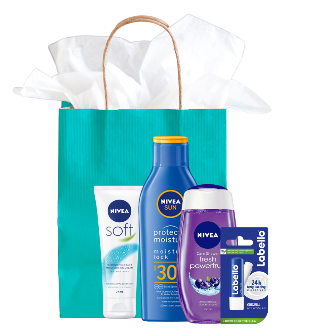 A picture of a gift bag with various Beiersdorf products in front of it, including hand cream, sun protection, body wash and Lip balm