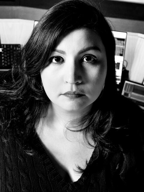 Maria Rice is a Latin woman with dark hair. She is wearing a dark shirt.