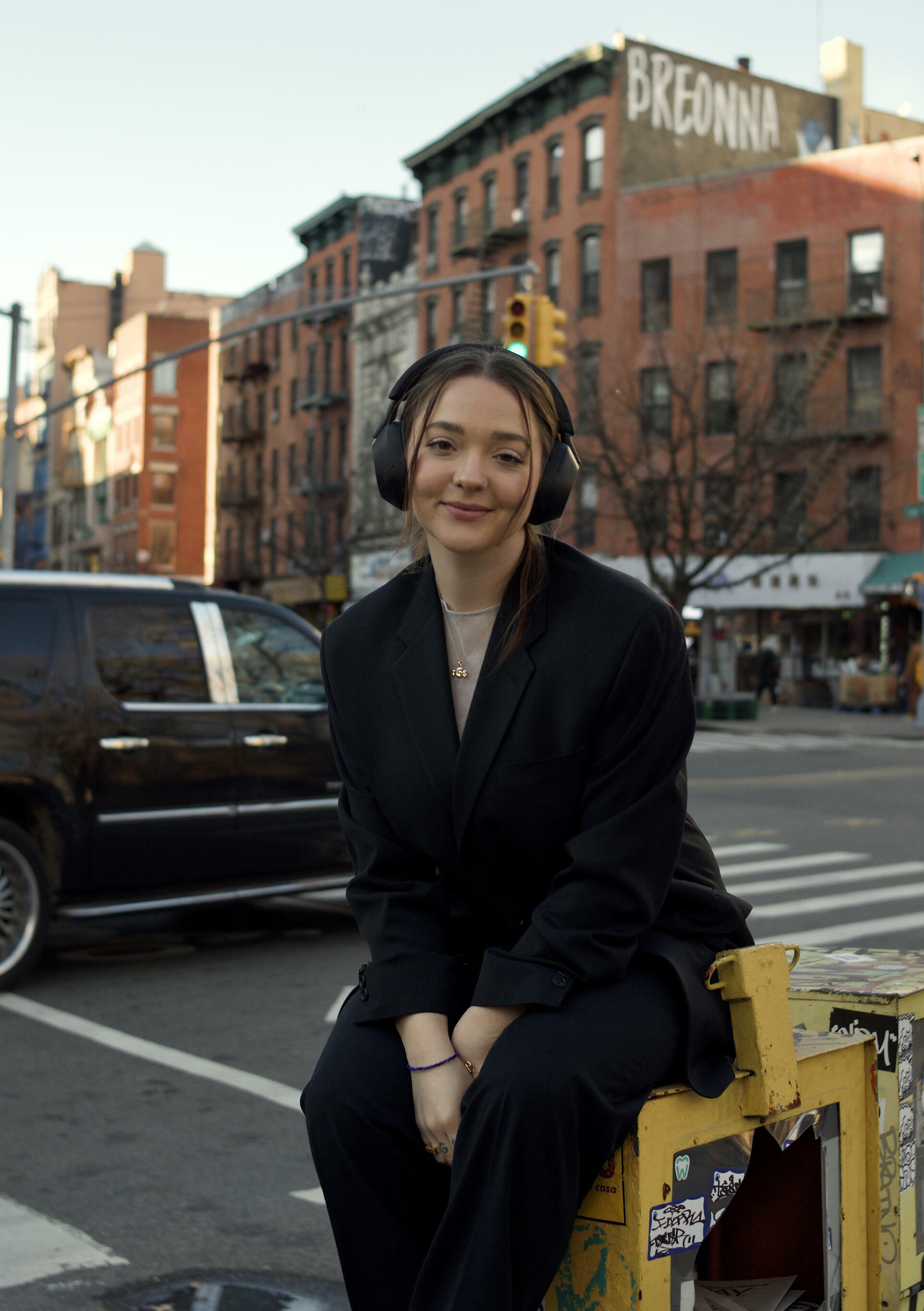 Annabelle is a white woman wearing a balck suit and headphones