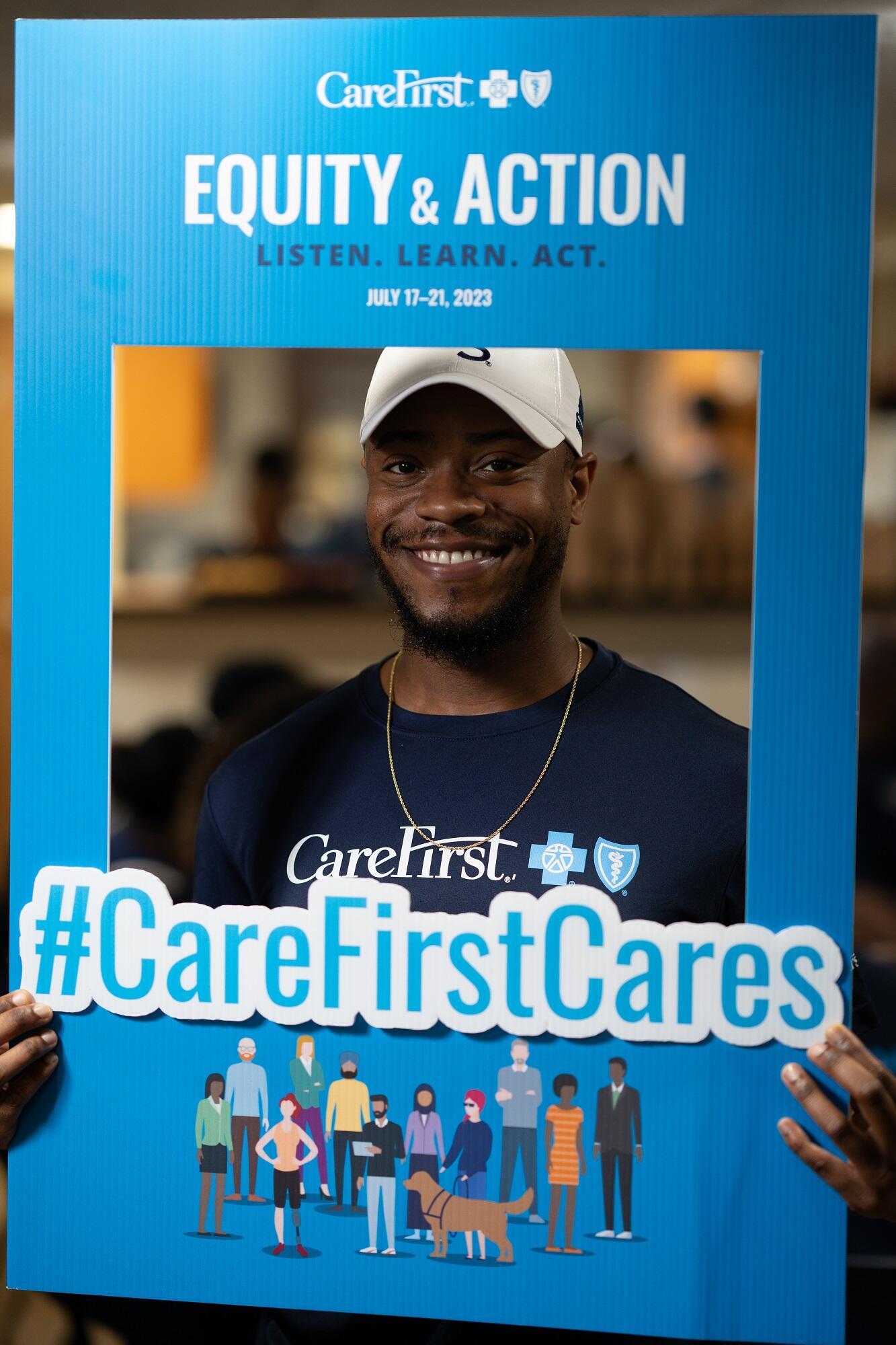 Employee posing with #carefirstcares social media frame