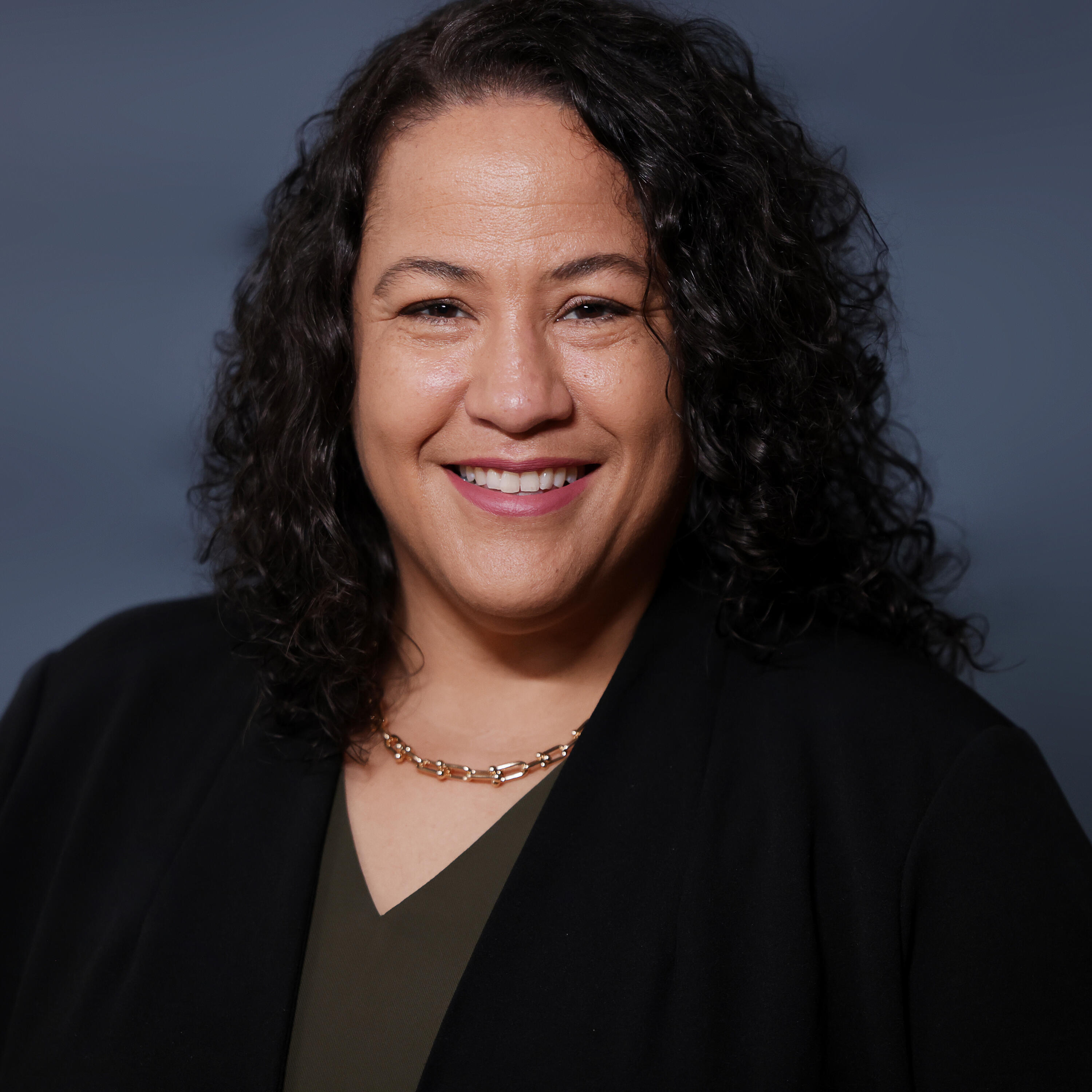 Smiling woman with dark curly hair