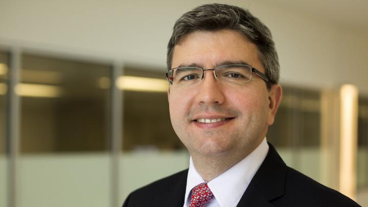 Smiling man in a suit with glasses