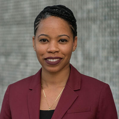 Smiling African American woman in maroon blazer