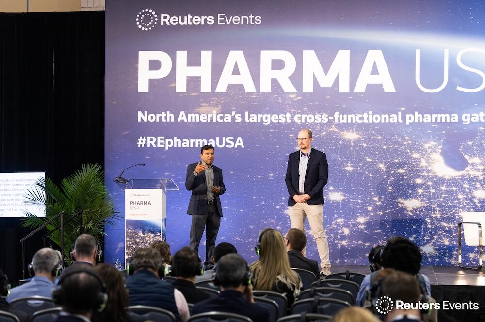 Photo of a person on a stage at one of the Reuters events conferences.