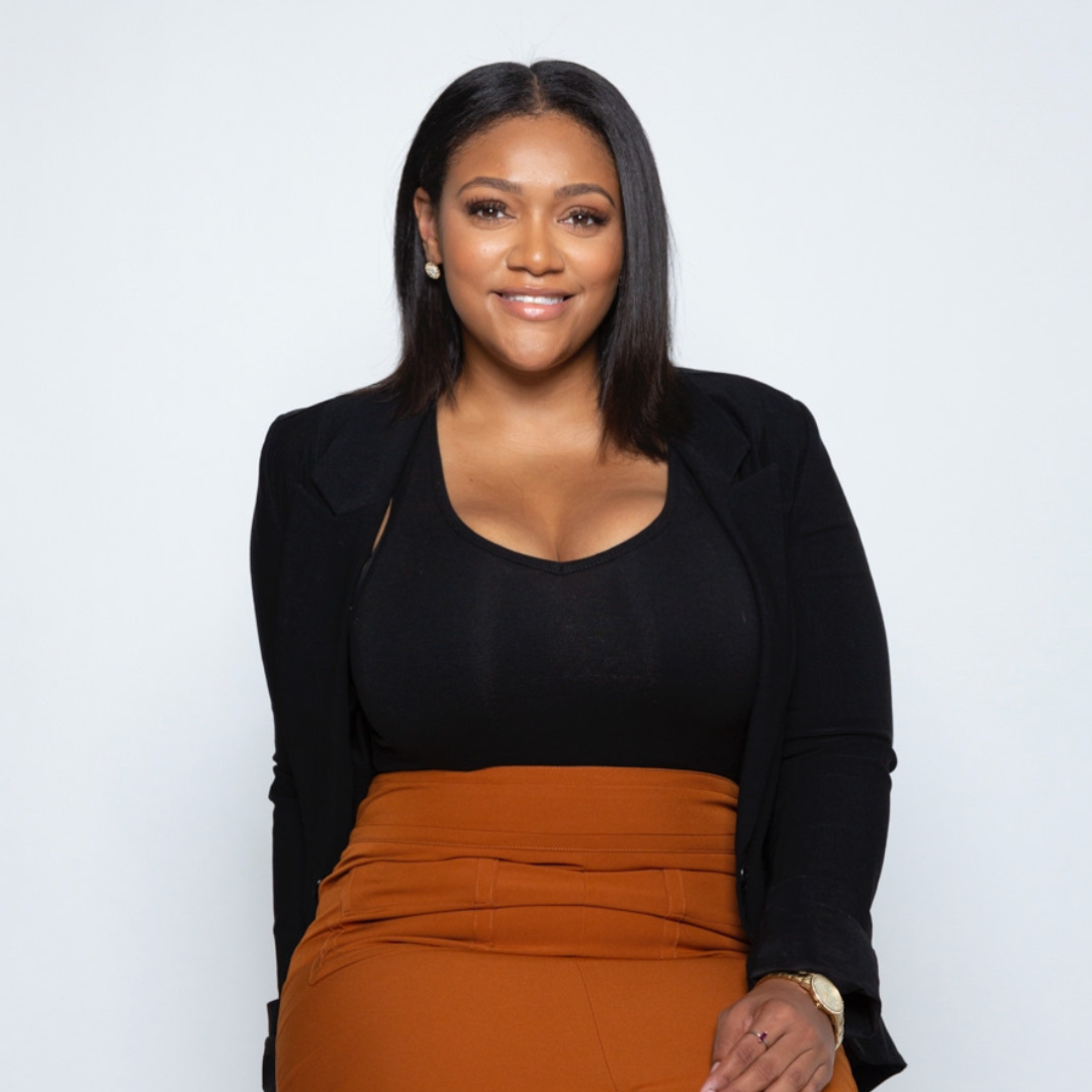 Portia is a woman with black shoulder length hair wearing a black long sleeve shirt.