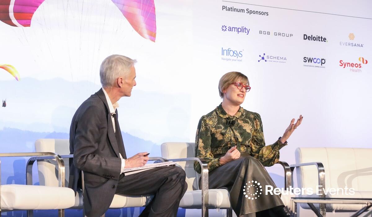 A speaker and moderator onstage at Pharma USA