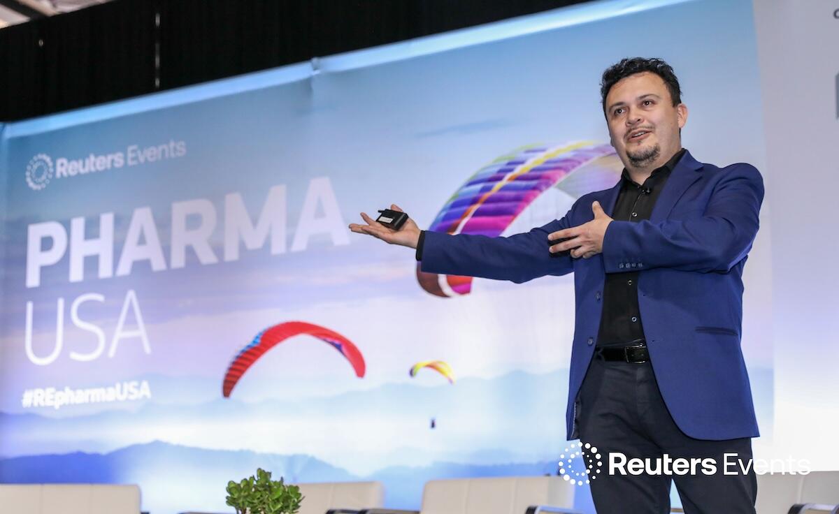 Speaker onstage gesturing at Pharma USA