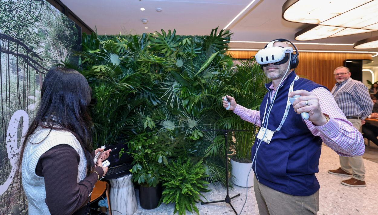 Attendees try virtual reality headsets at a Reuters NEXT experiential exhibition space.