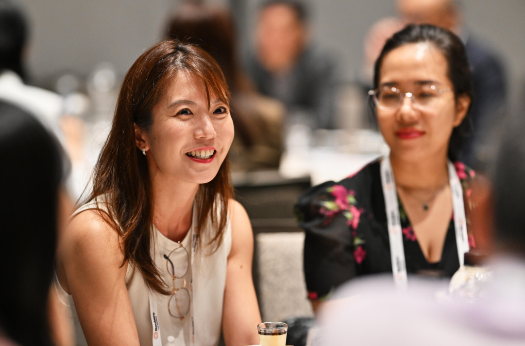 Attendee smiles during a Reuters NEXT Asia session.