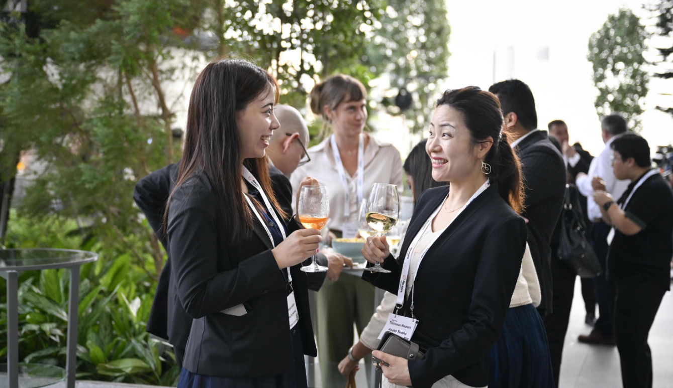 Attendees networking outdoors at Reuters NEXT.