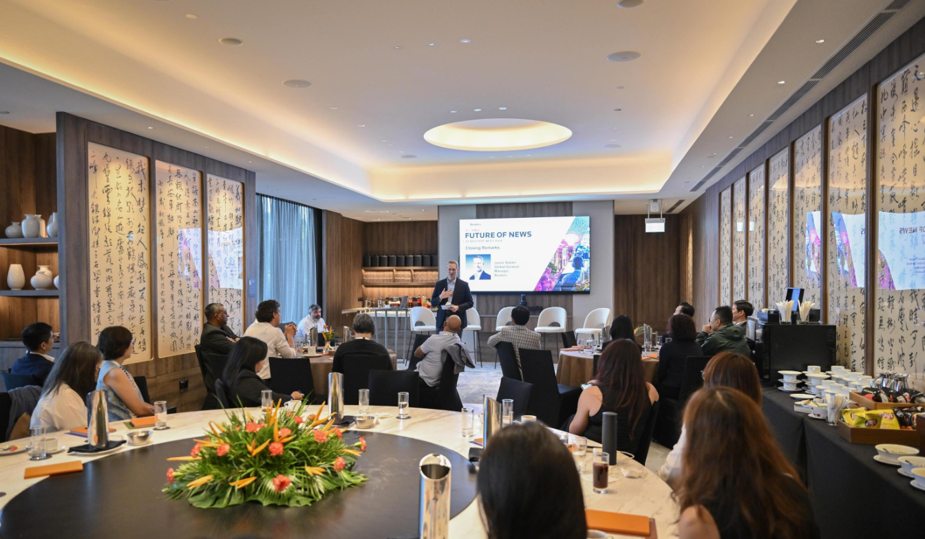 Conference breakout session with attendees seated and a speaker at the front at Reuters NEXT.