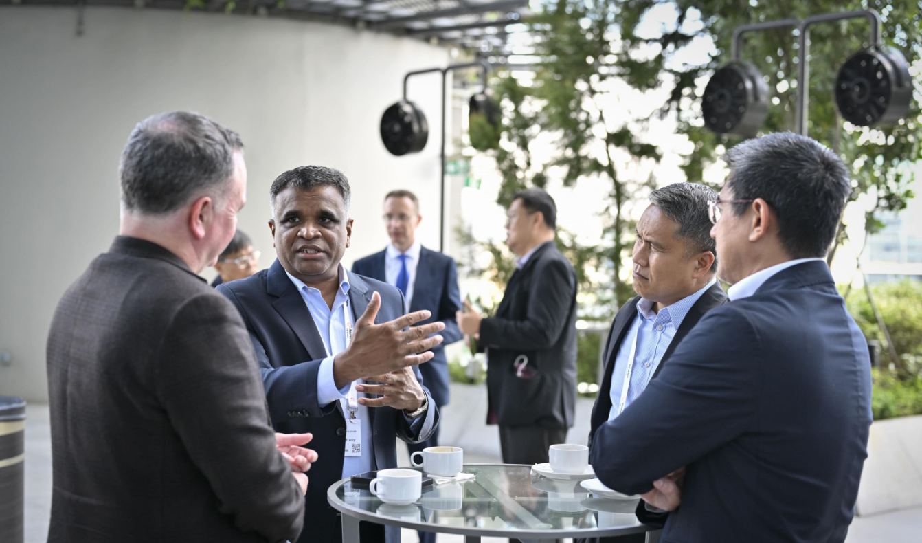 Attendees networking and talking over coffee at Reuters NEXT.