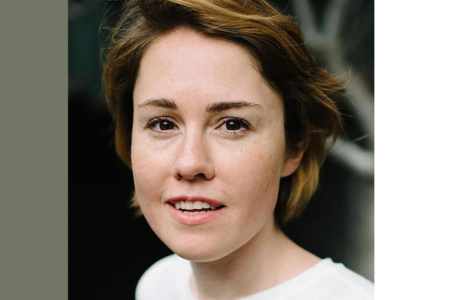 Headshot of Caroline Shaw, young white woman with short light brown hair, wearing white t-shirt