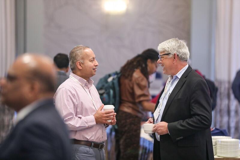 Two delegates networking over coffee