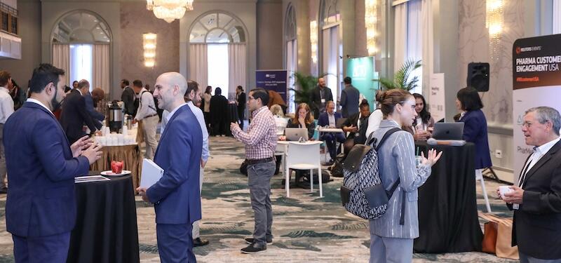 Professionals networking and discussing at Pharma Customer Engagement USA conference