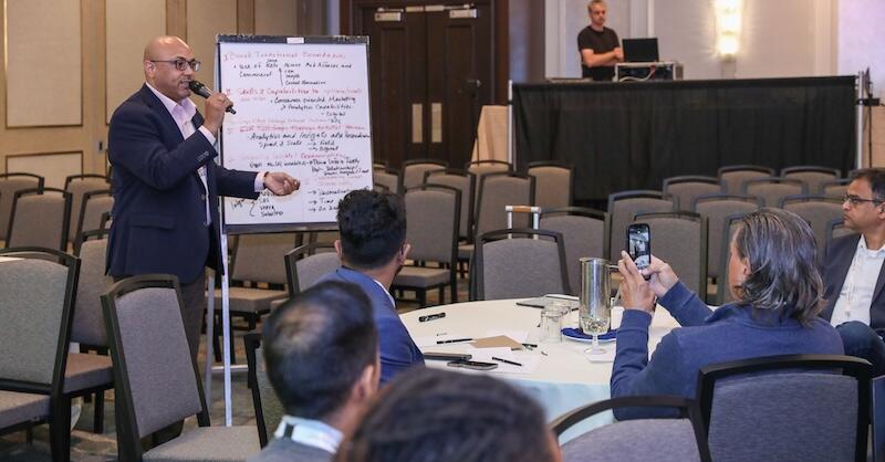 A speaker presenting a keynote to a group of delegates
