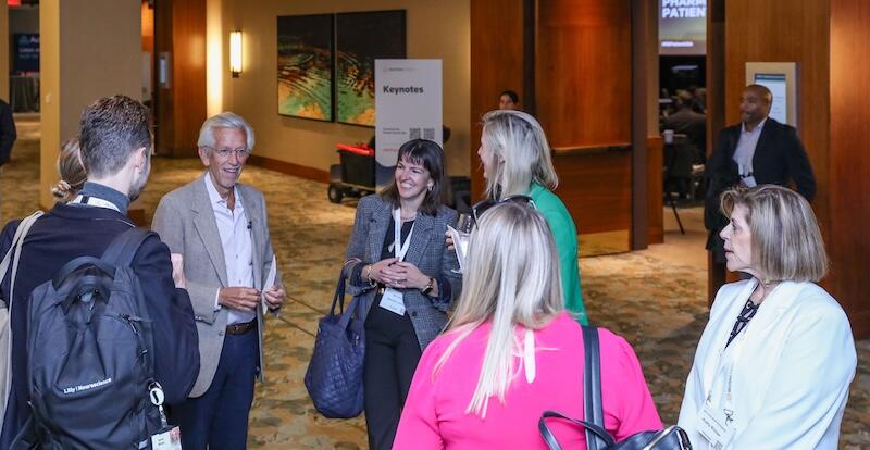 A photo of a room full of people at a networking break