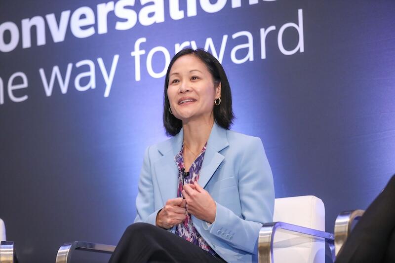 a person wearing a blue blazer sitting on a chair