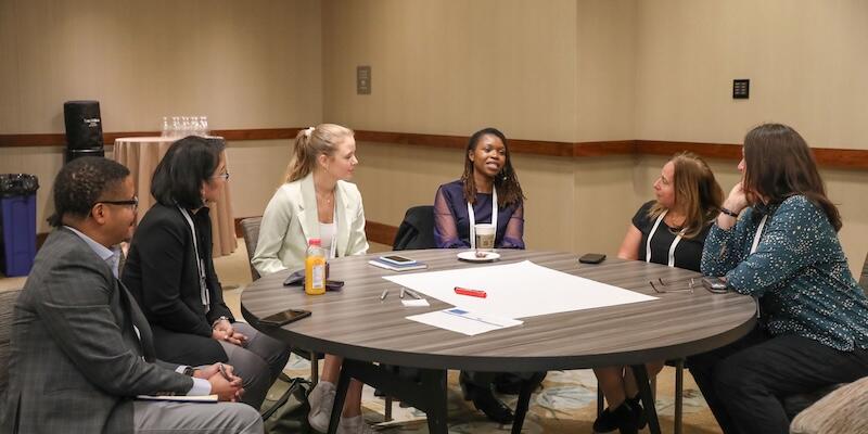 A roundtable discussion taking place with 6 people. 