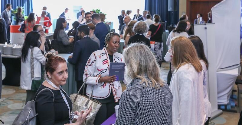 A photo of a room full of people at a networking break