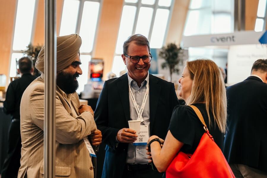 Three people talking over coffee networking