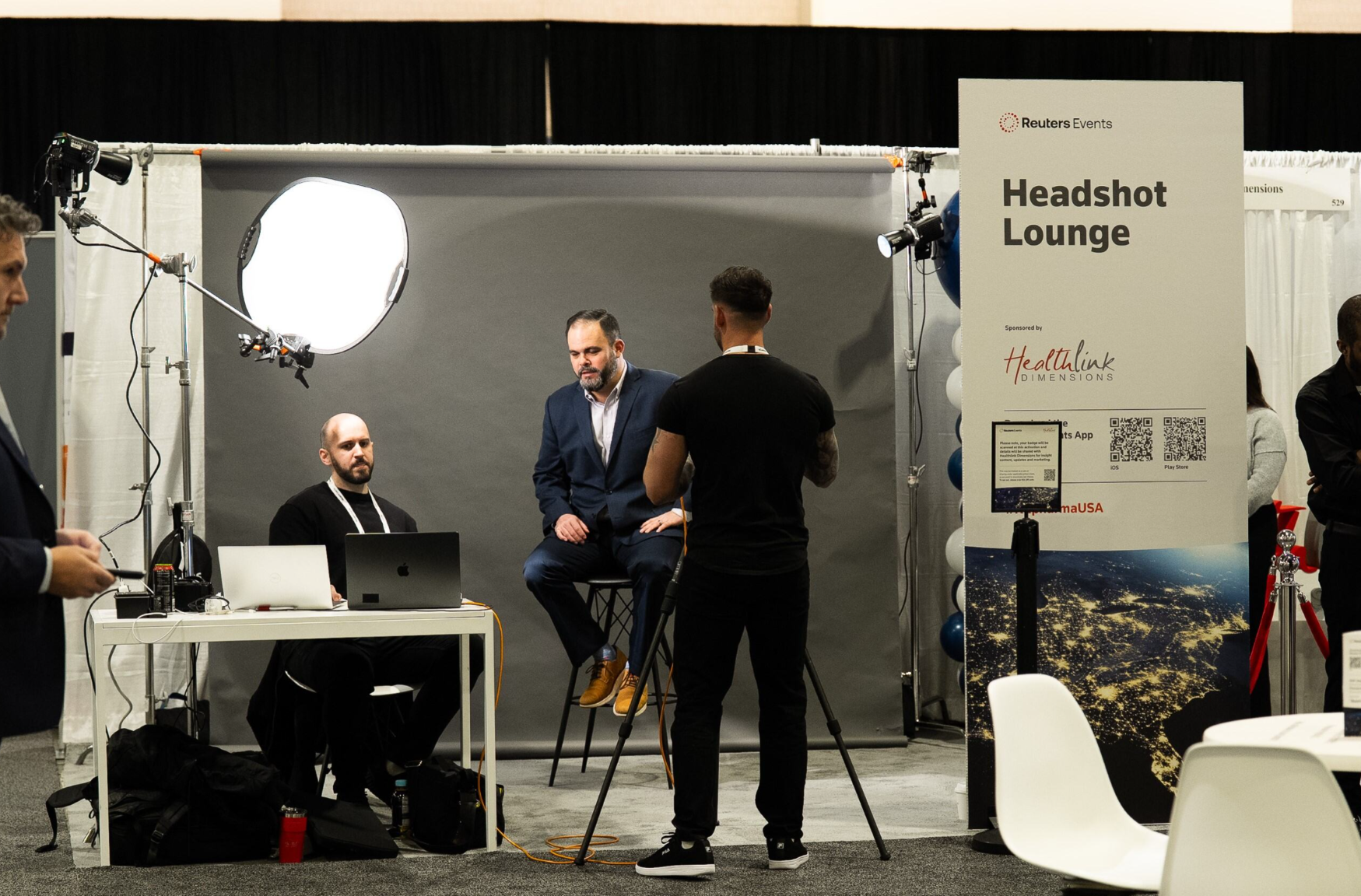 Attendee getting a professional headshot taken at the Reuters Events Headshot Lounge, sponsored by Healthlink Dimensions, at Pharma USA.
