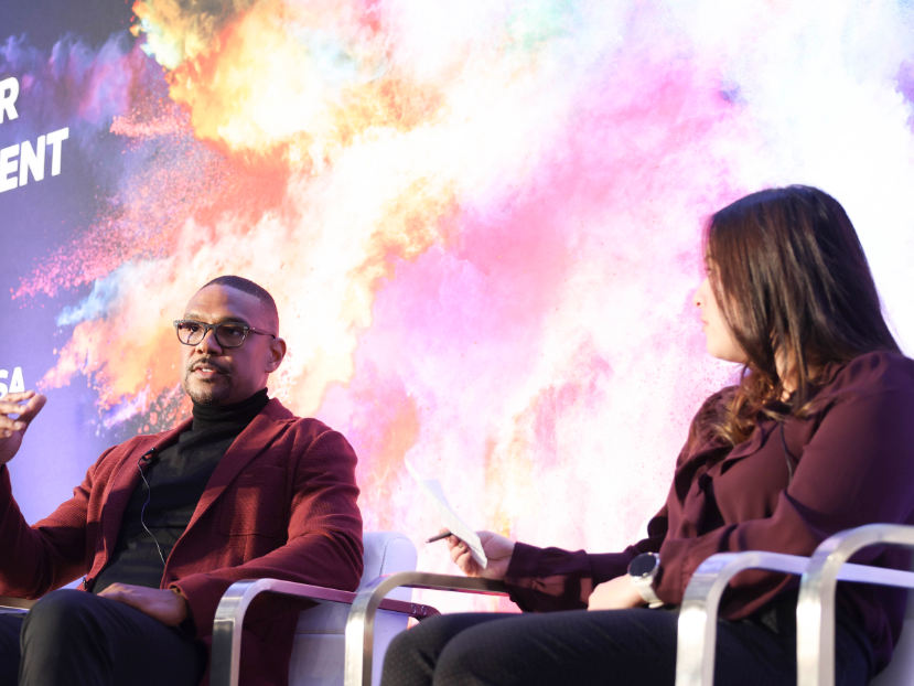 2 speakers on stage during a panel