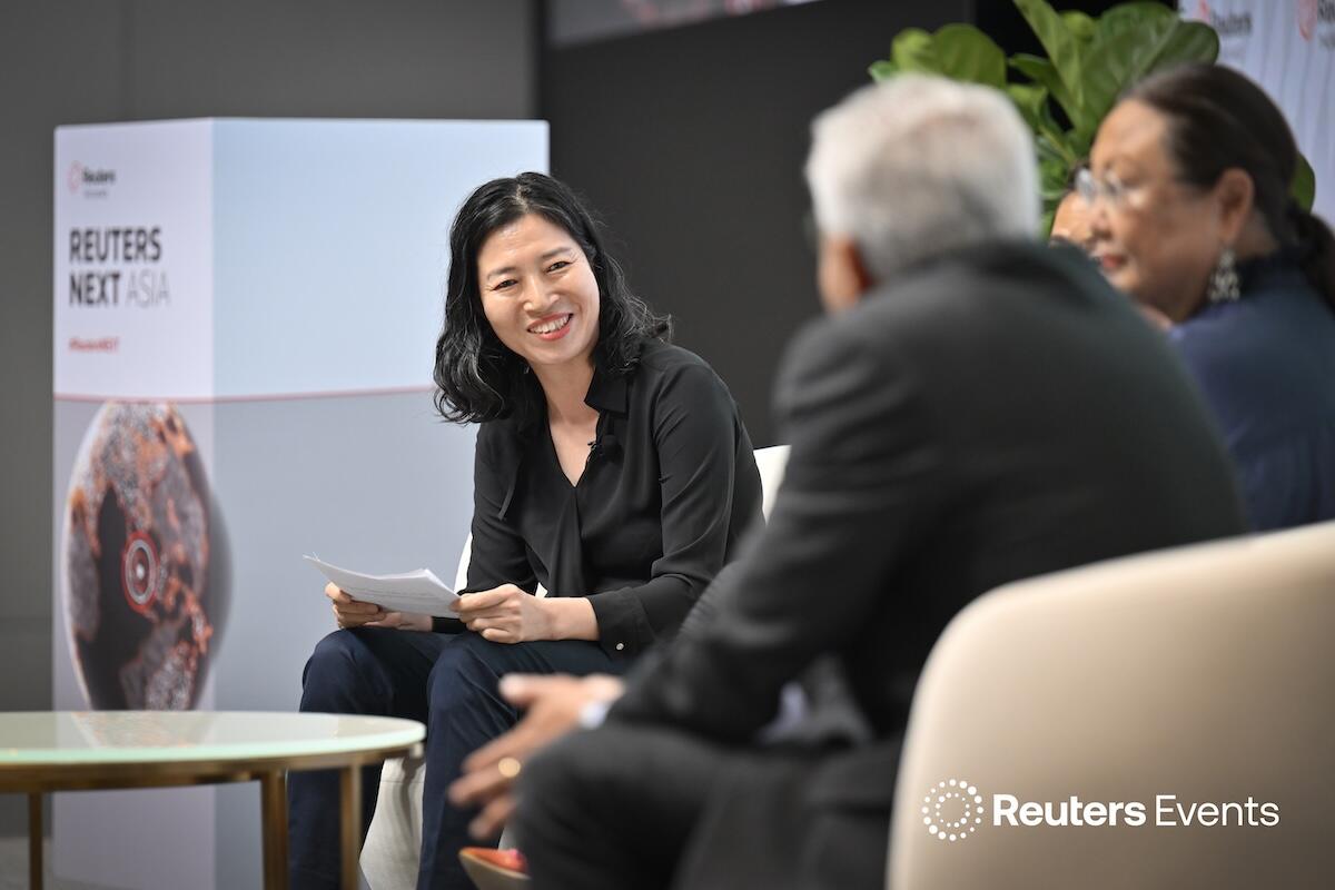 Photo of three people on the stage having a discussion at Reuters Next Asia 2025
