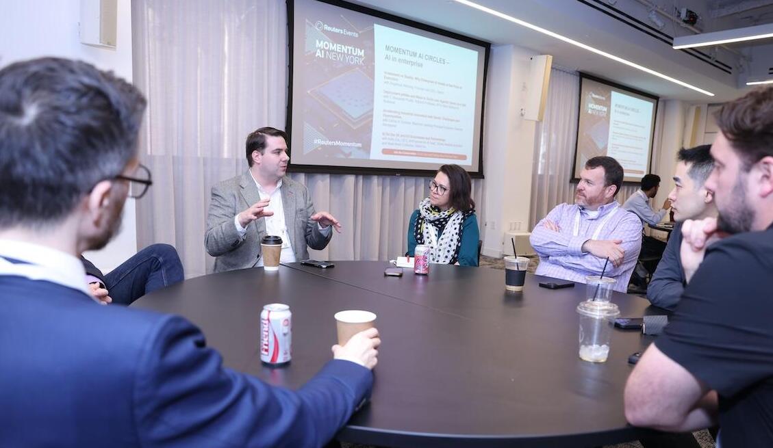 A group of people at a roundtable discussing a topic