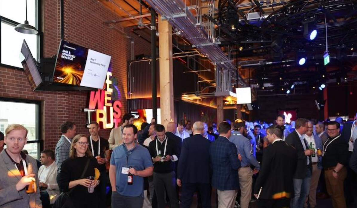 Day 1 networking party at the SMR & Advanced Reactor conference, crowded reception with signage and stage lighting.