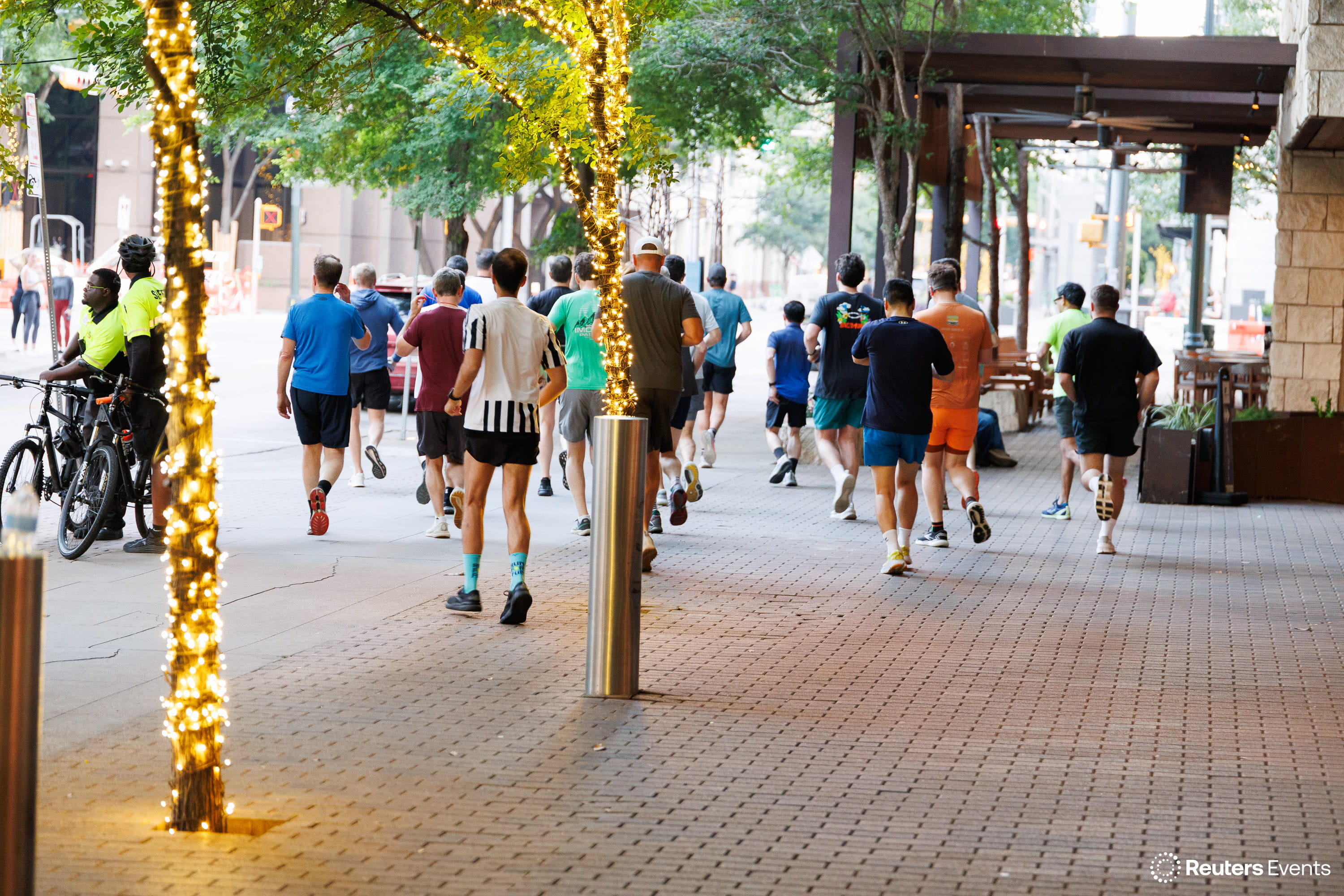 Large group of conference attendees on a morning run along a city street