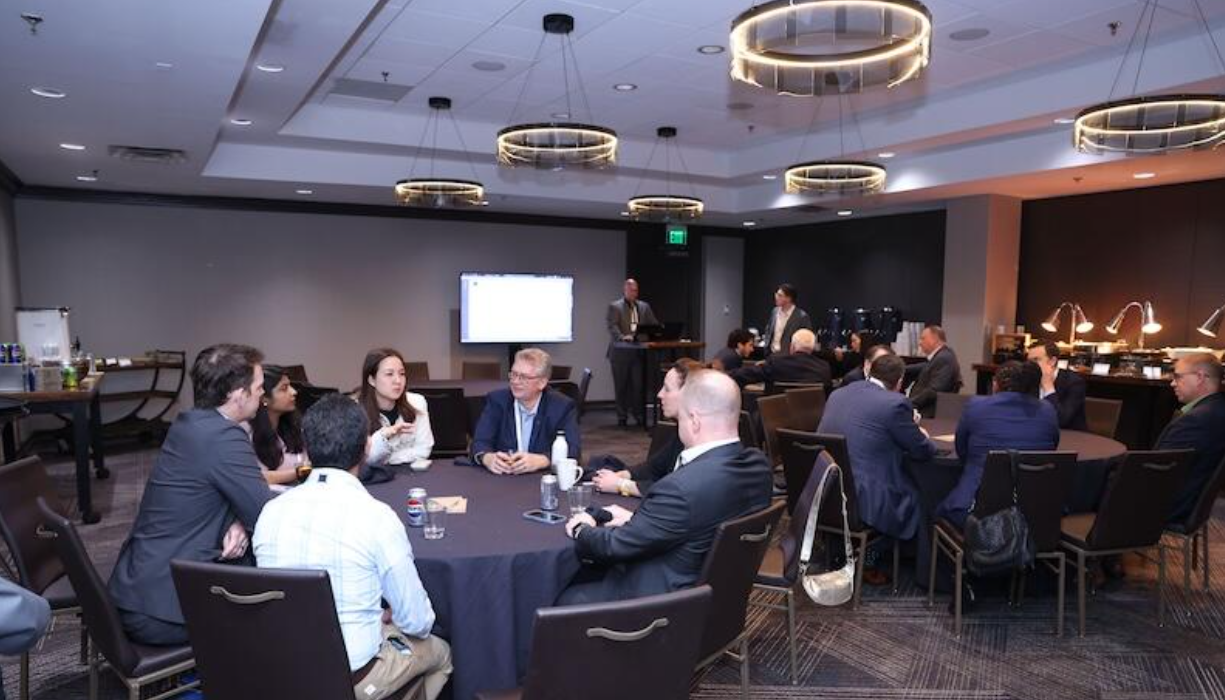 Roundtable discussions at the SMR & Advanced Reactor conference, with screen and refreshments in a modern meeting room.