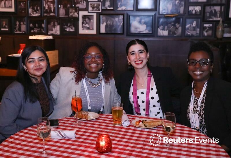 4 people smiling at the networking dinner at the Supply Chain USA show