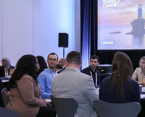 A group of people at a roundtable discussing a topic at the Supply Chain USA show