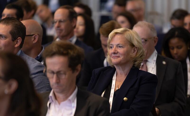 Close-up of audience members listening attentively during a business event.