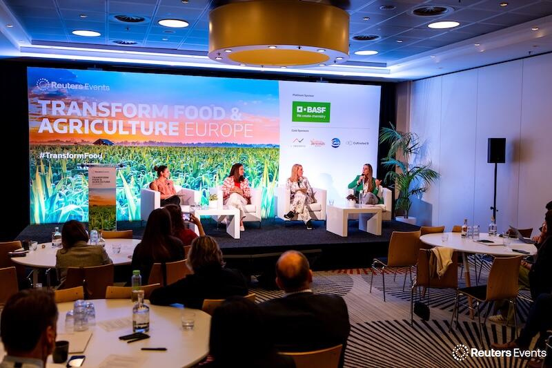 A group of presenters on stage sitting down at a Transform Food & Agriculture event