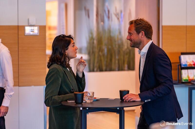 Two people discussing and networking at our event over coffee.