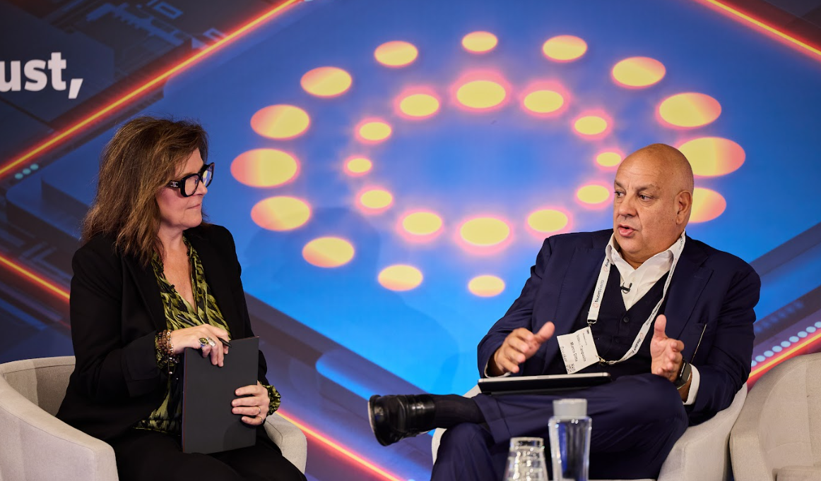Two speakers in discussion on a panel at the Momentum AI London conference.