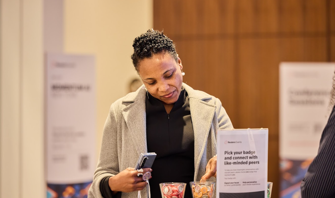 Attendee selecting a badge at the Momentum AI London conference