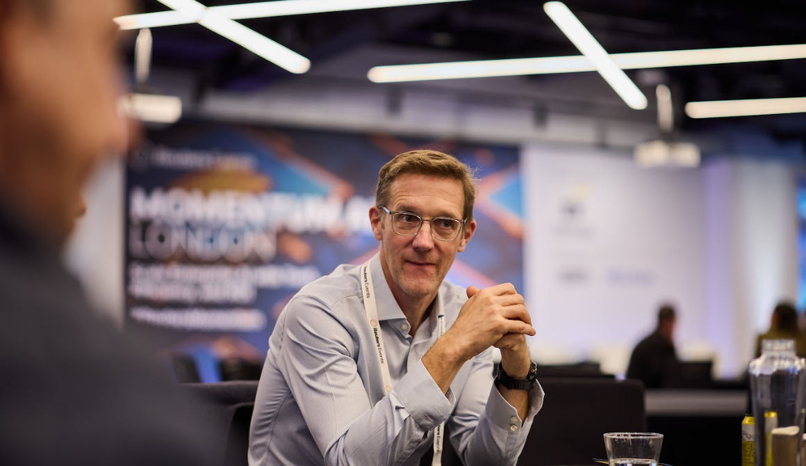 Attendee in conversation at the Momentum AI London conference.
