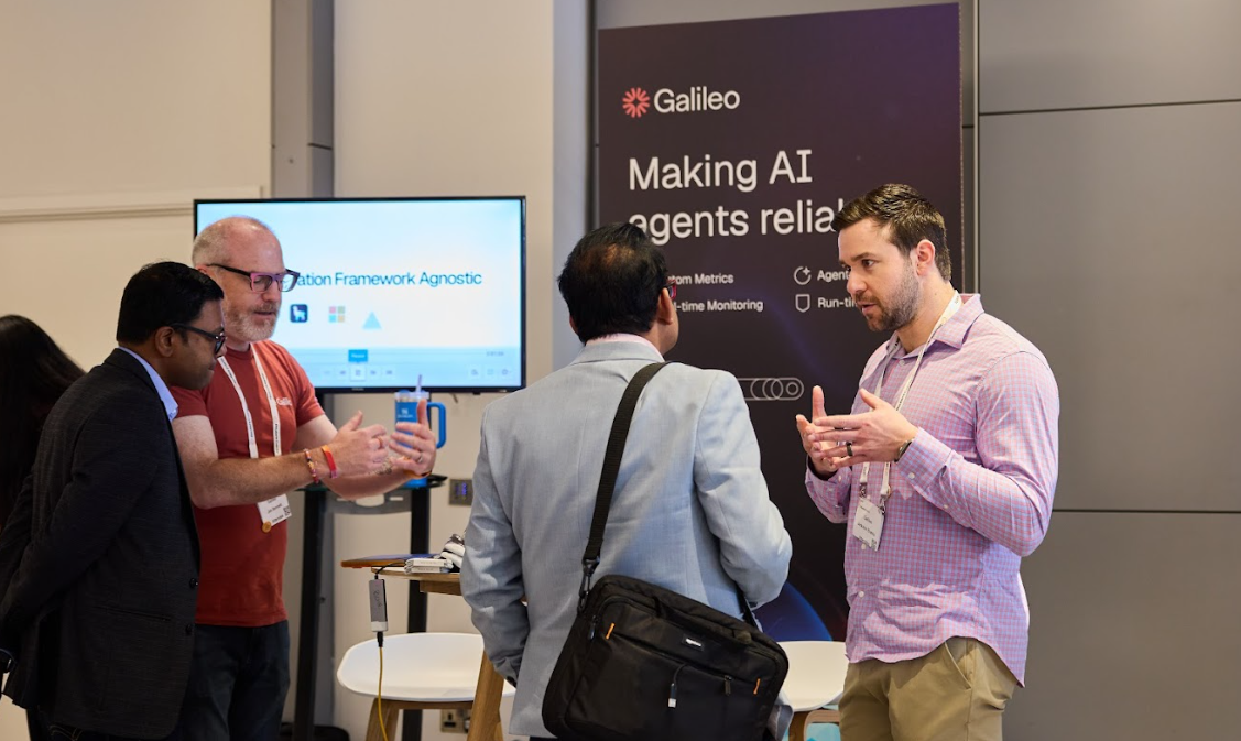 Attendees speaking with an AI vendor at the Momentum AI London conference.
