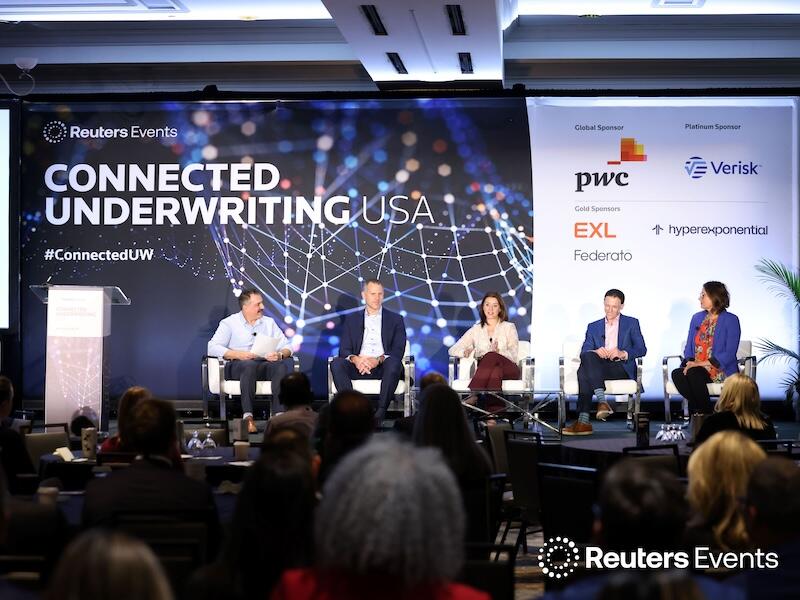 5 speakers on stage at a  Connected Underwriting USA event
