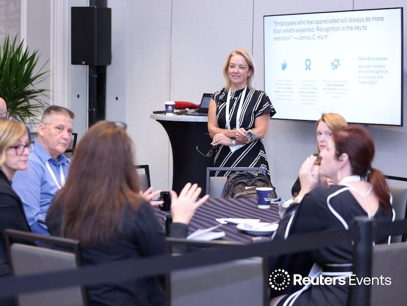 A roundtable discussion with a speaker asking questions at  Connected Underwriting USA