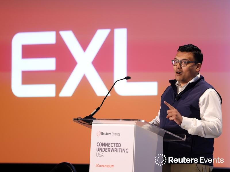 Speaker presenting on stage with “Strategic Marketing” backdrop, engaging the audience with a hands‑on talk