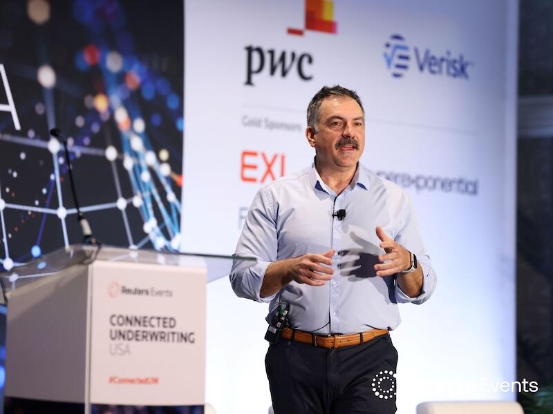 A speaker on stage talking at  Connected Underwriting USA