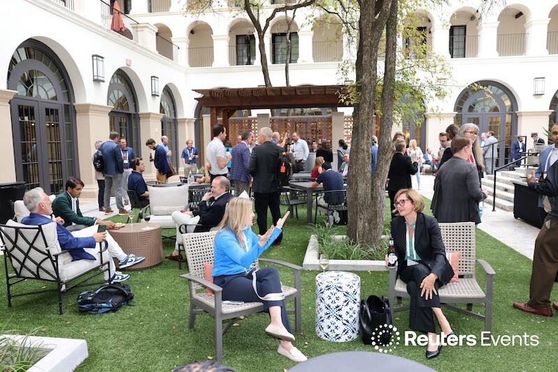 People in an outside area networking at  Connected Underwriting USA