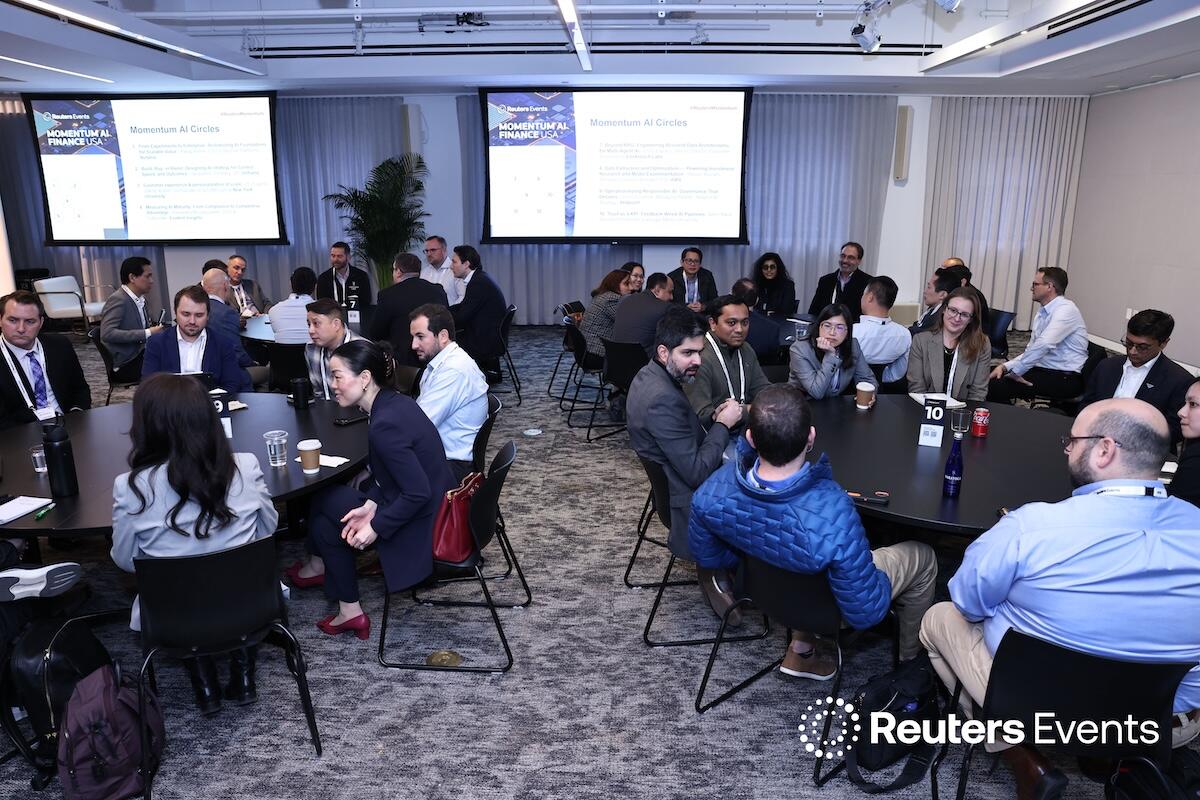 A room of round tables with people networking at the Momentum AI Finance USA Event