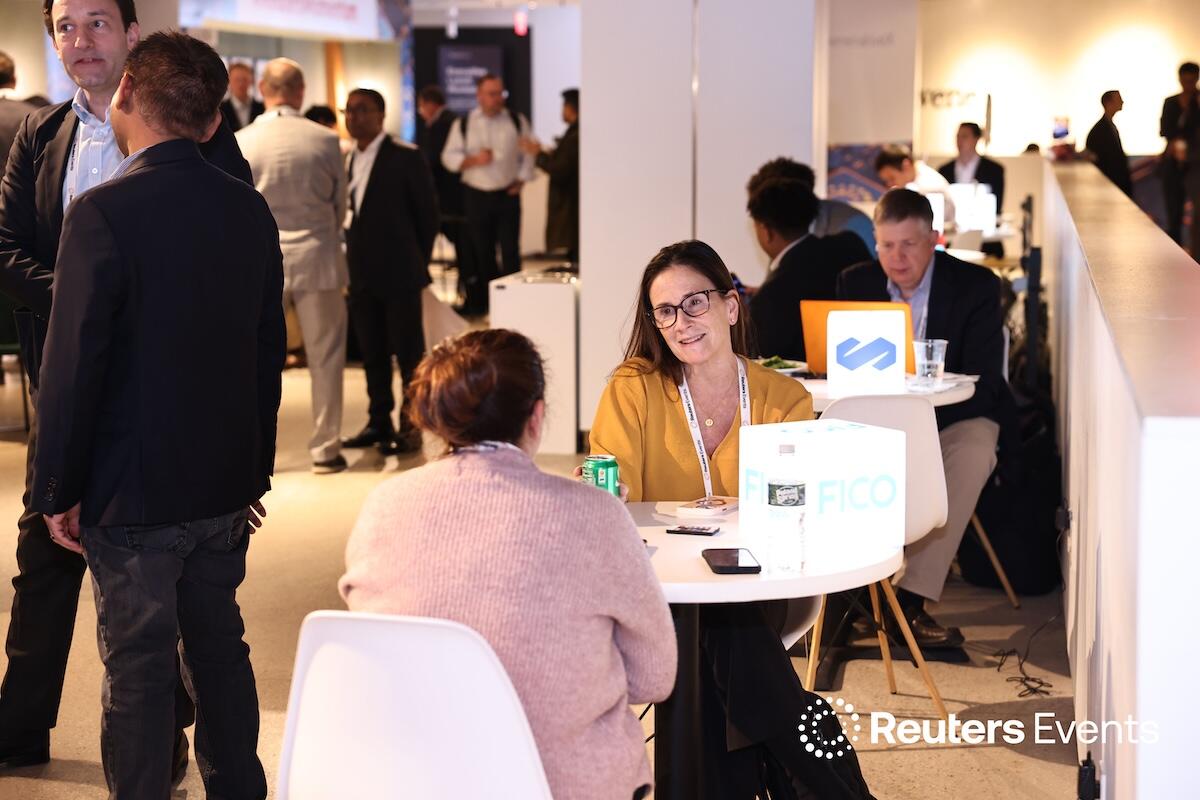 Two people discussing and networking at our event over coffee at the Momentum AI Finance USA Event